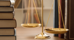 bunch of law books and a scale weighing machine is placed on the table