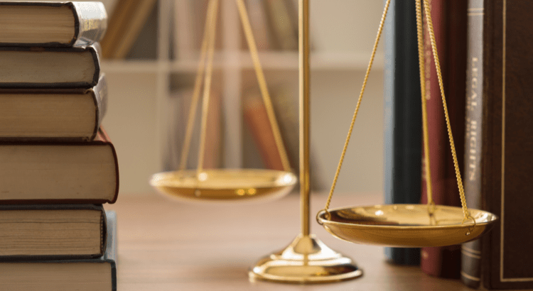 bunch of law books and a scale weighing machine is placed on the table