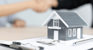 small demo of house kept on the notepad with a key