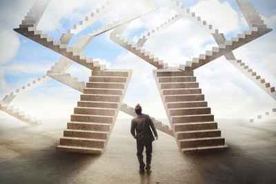 two staircases clouds and a man walking towards the stairs