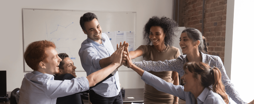 Team mates are giving high five to each other and laughing together