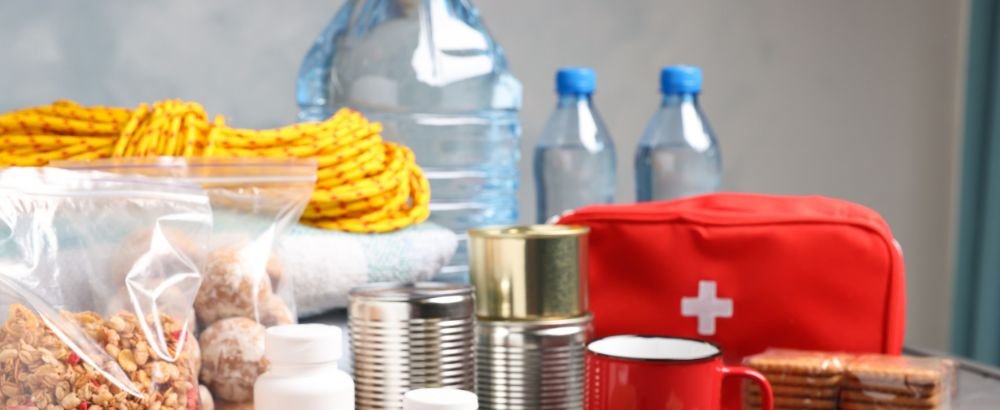 First aid bag, rope, water bottle and some snacks are kept on the table
